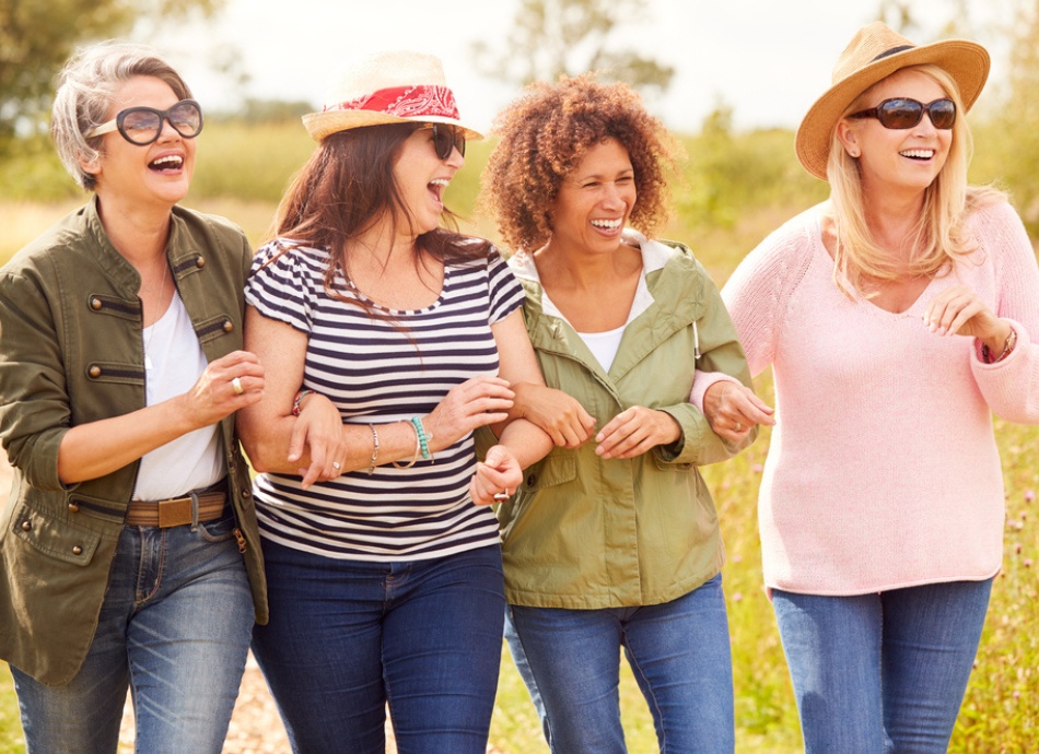 4 women friends walking outside and laughing