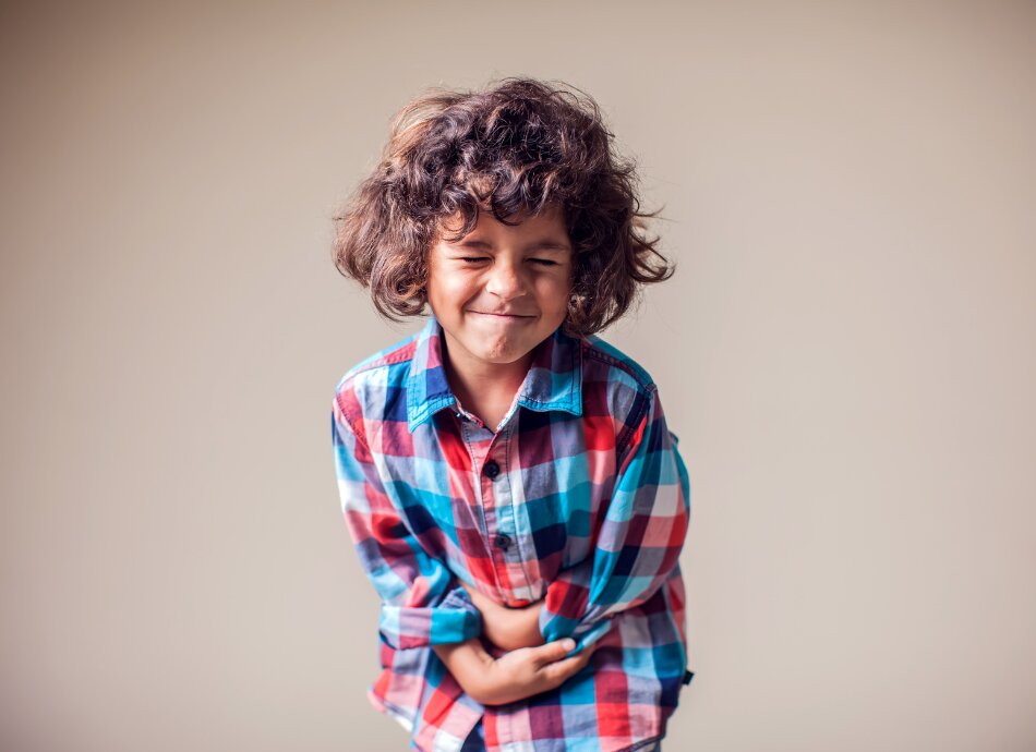 Child clutches his stomach in pain