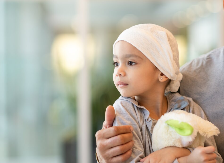 Young girl with leukaemia wearing head scarf