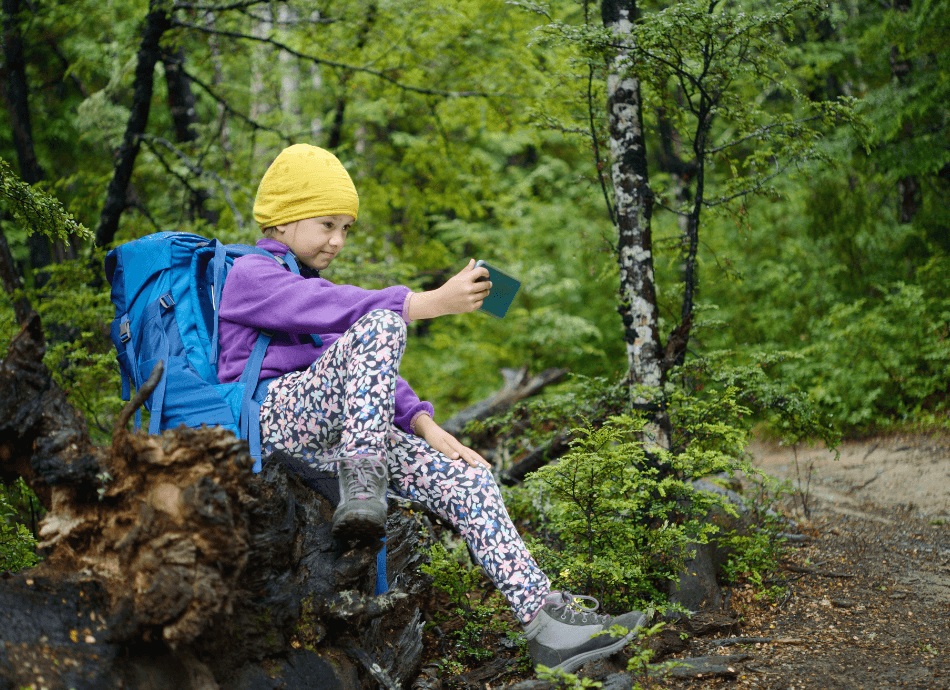 Girl taking selfie on a walk in the New Zealand bush
