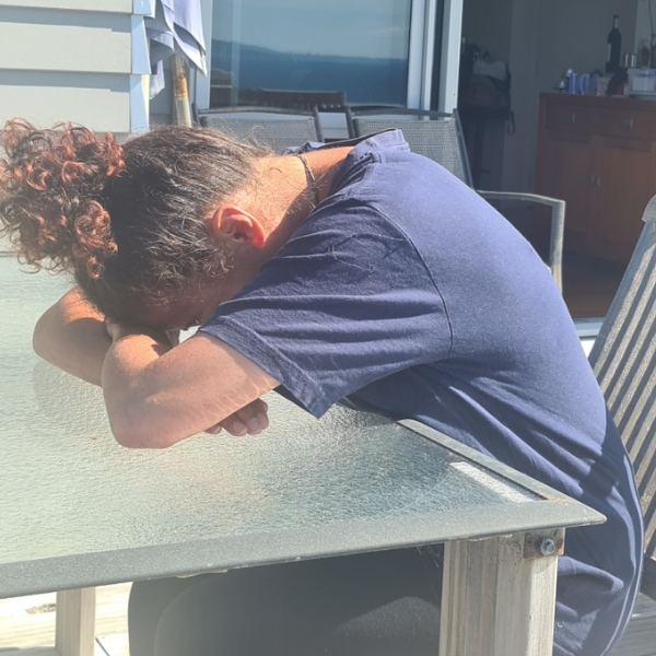 Woman leaning on table with head forward