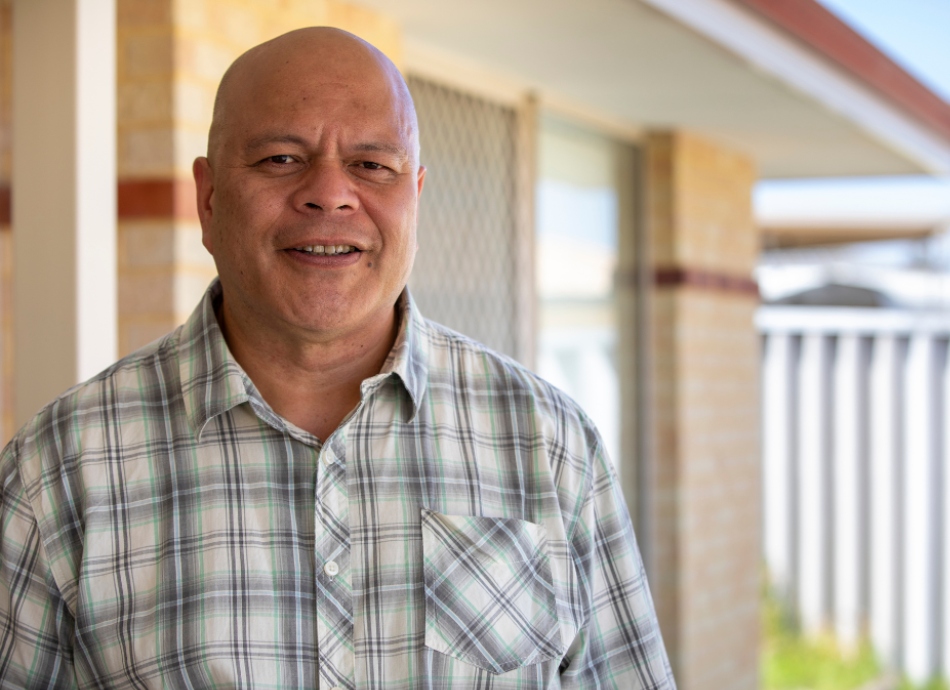 Middle-aged Pasifika man outside his house