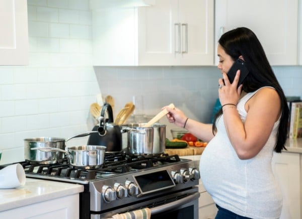 Pregnant woman cooking on stove