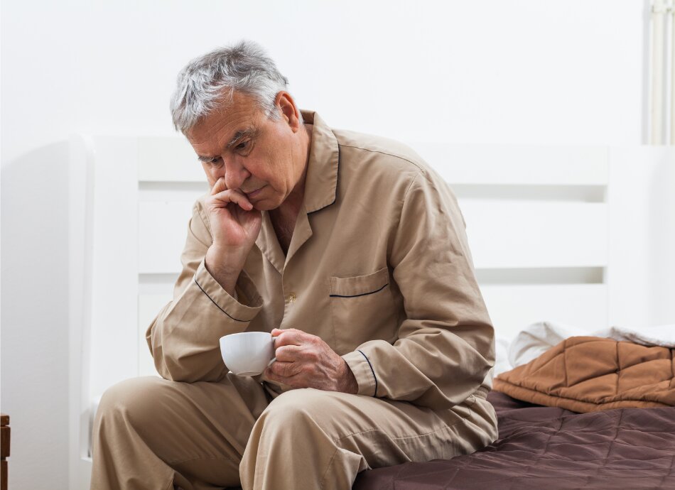 Sleepless older man wearing pyjamas