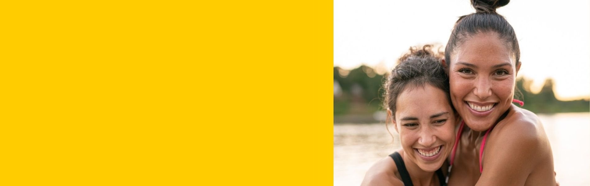 Two sisters smiling and hugging slider