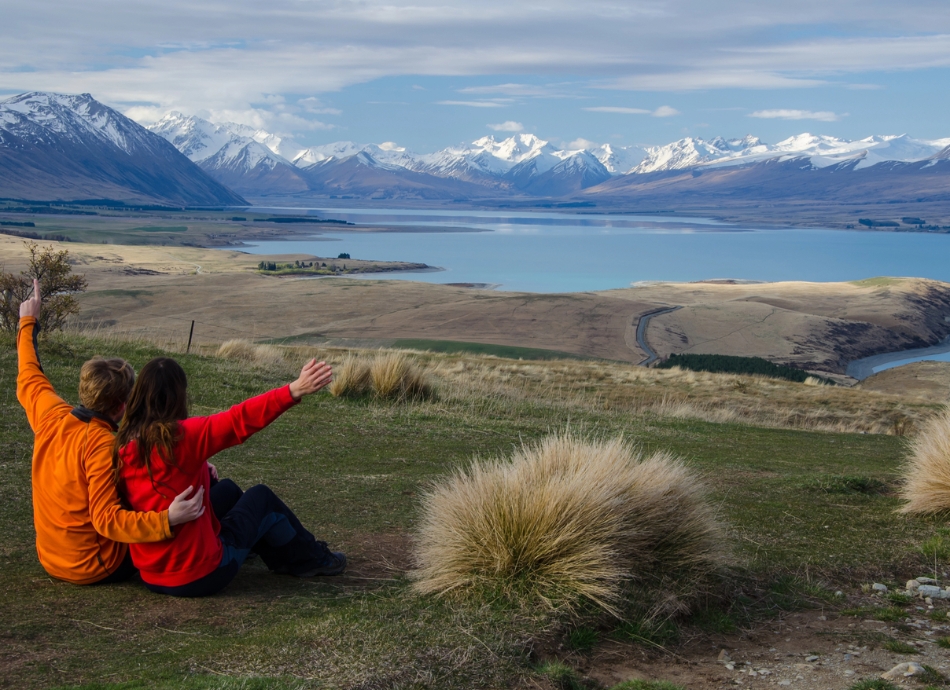 Young couple looking at Lake Tekapo 
