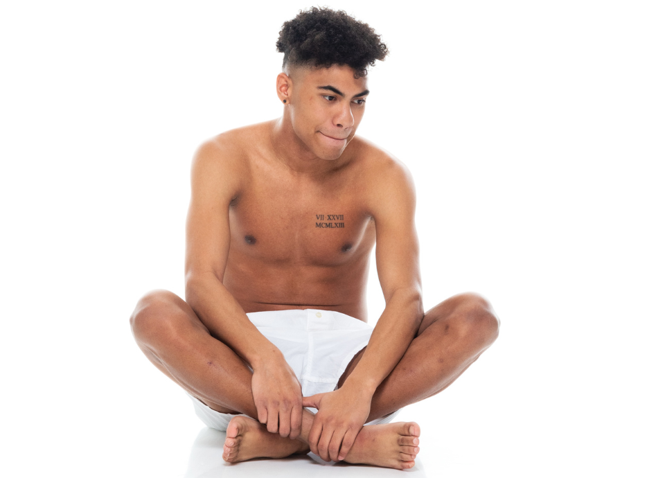 Man sitting cross legged in boxer shorts