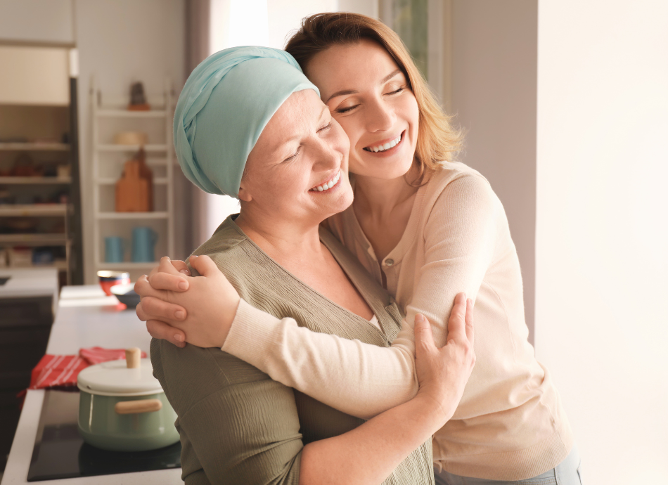 Woman with cancer hair loss embracing friend