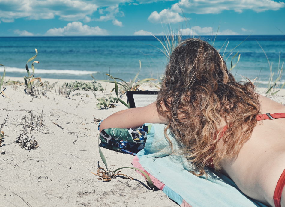 Young woman sunbathing in bikini on beach